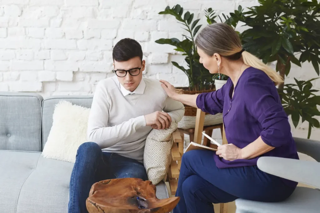 A man receiving emotional support in counselling, reflecting the importance of guided detox for better wellbeing.