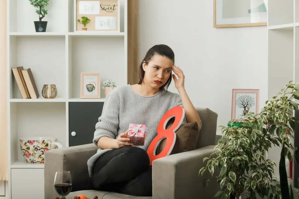 A woman feeling low indoors, showing how mood changes can increase alcohol struggles and the need for home detox support.